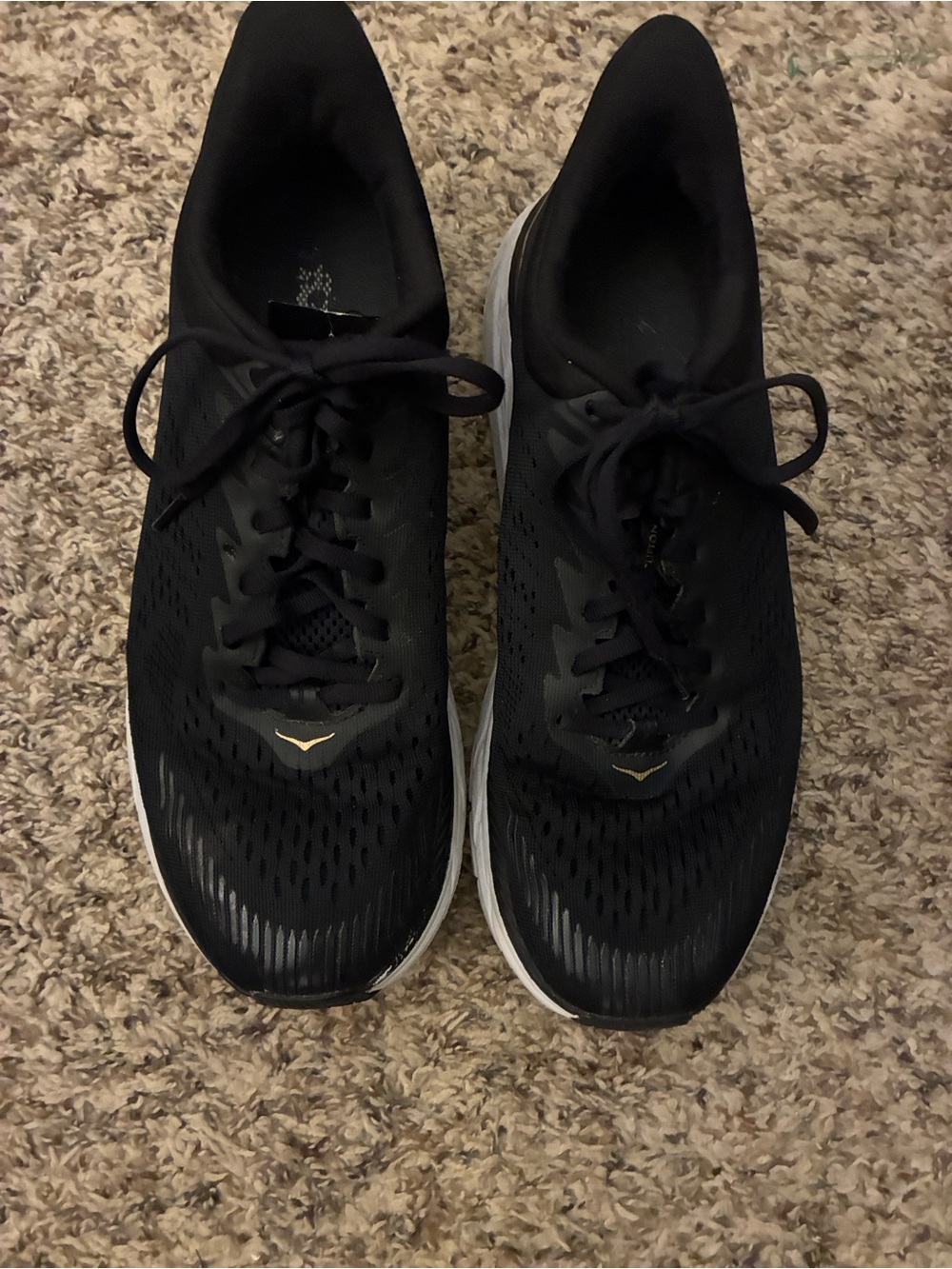 Hoka‎ Black Athletic Shoes with White Soles and Gold Accents